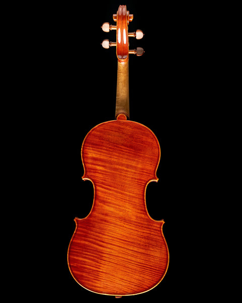 The one-piece curly maple backplate of a 2023 Daniel Cloutier violin